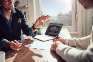 Client signing contract while real estate agent holding keys